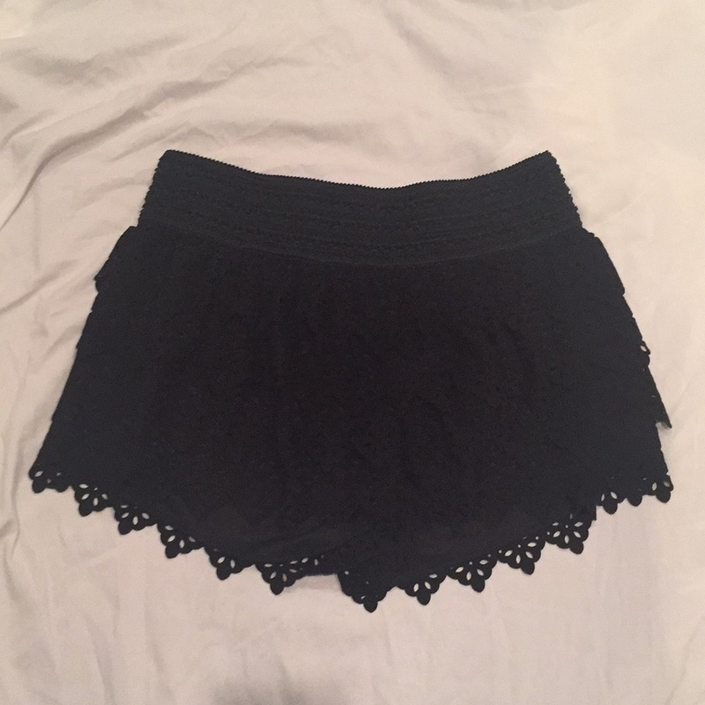 Black ruffled shorts.